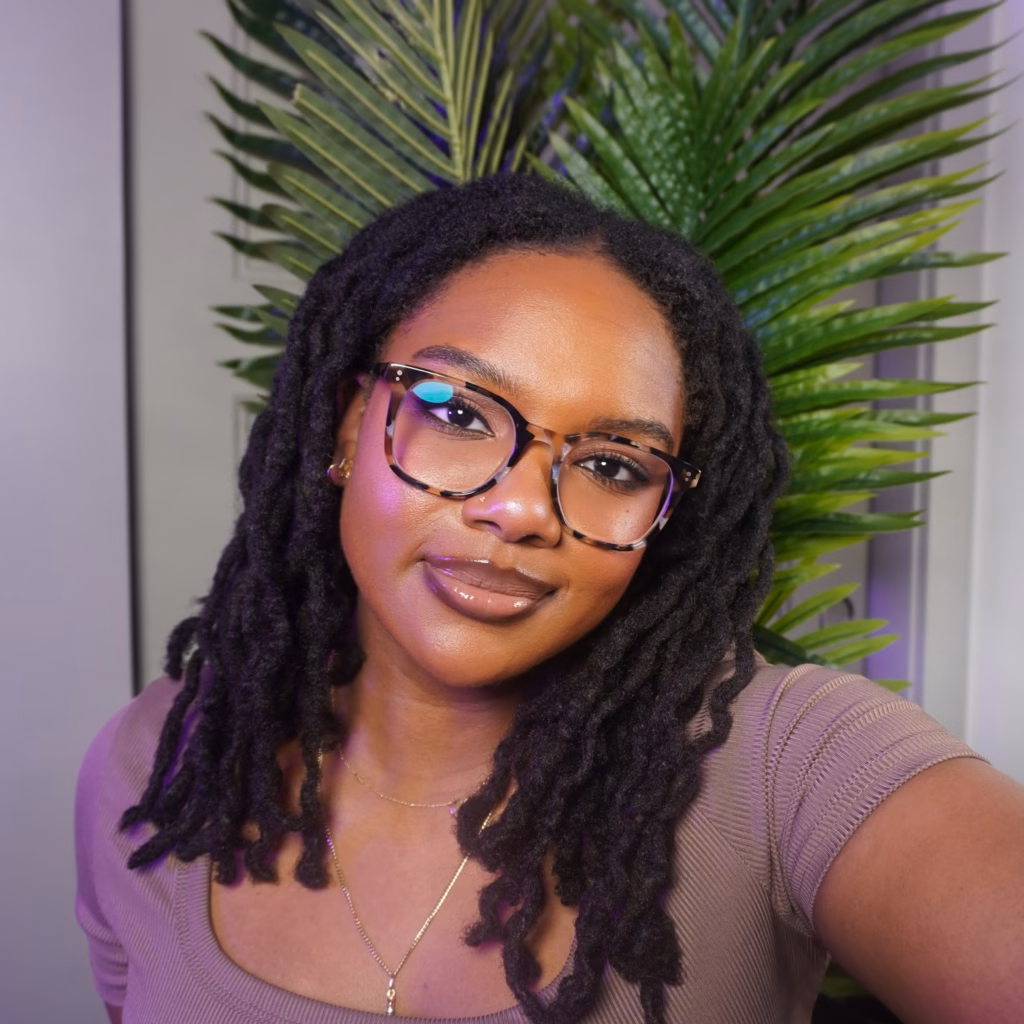 Curly Ended Locs With Speckled Tortoiseshell Frames and a Full Glam Beat