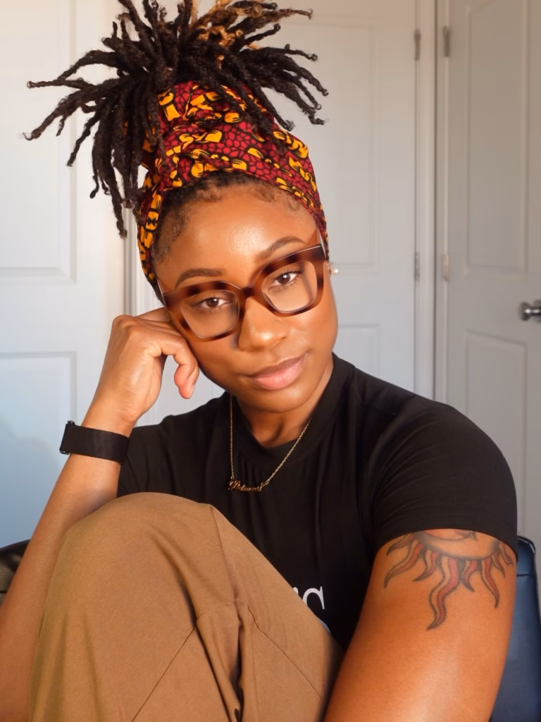 Locs Pinned Up With an African Print Head Wrap and Tortoiseshell Frames