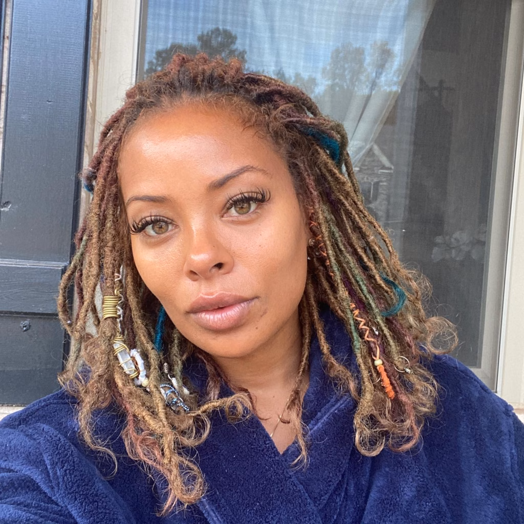 Medium Boho Locs with Colorful Accessories and Teal Highlights