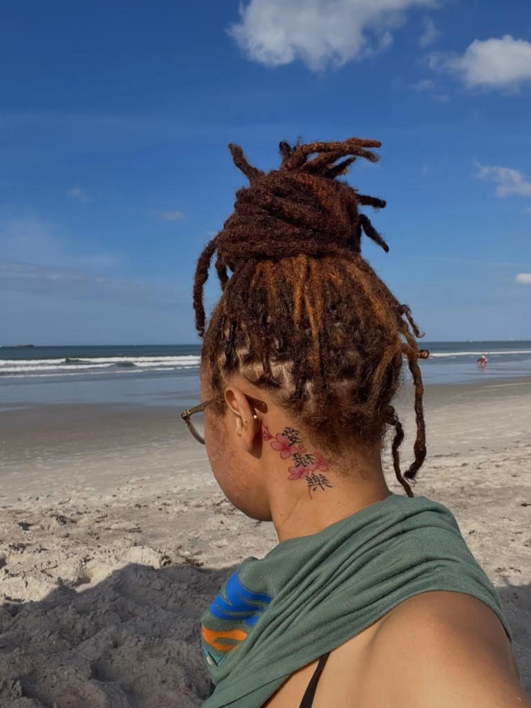 Messy Loc Updo With Loose Ends at the Beach