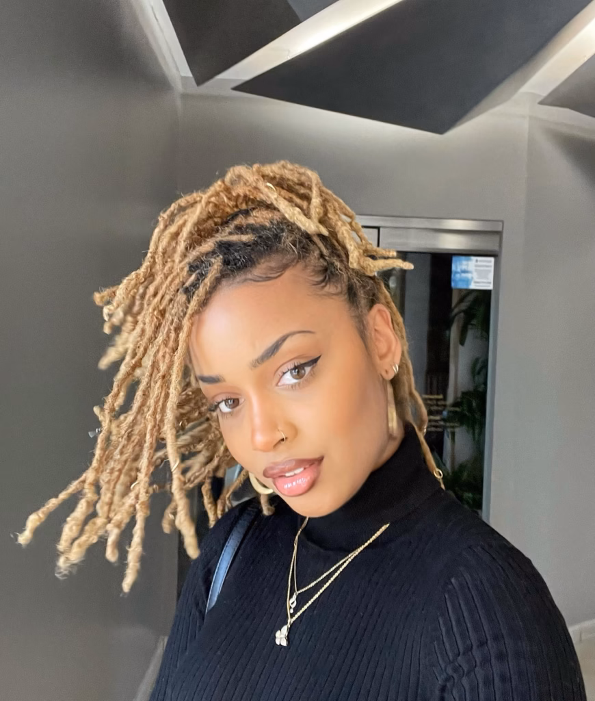 Short Golden Blonde Locs With Dark Roots Worn Loose and Tousled