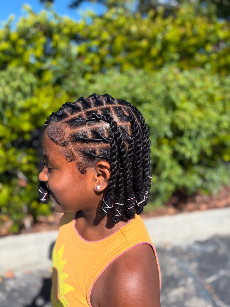 Short Twisted Locs with Pink String Wrapped Ends and Defined Edges
