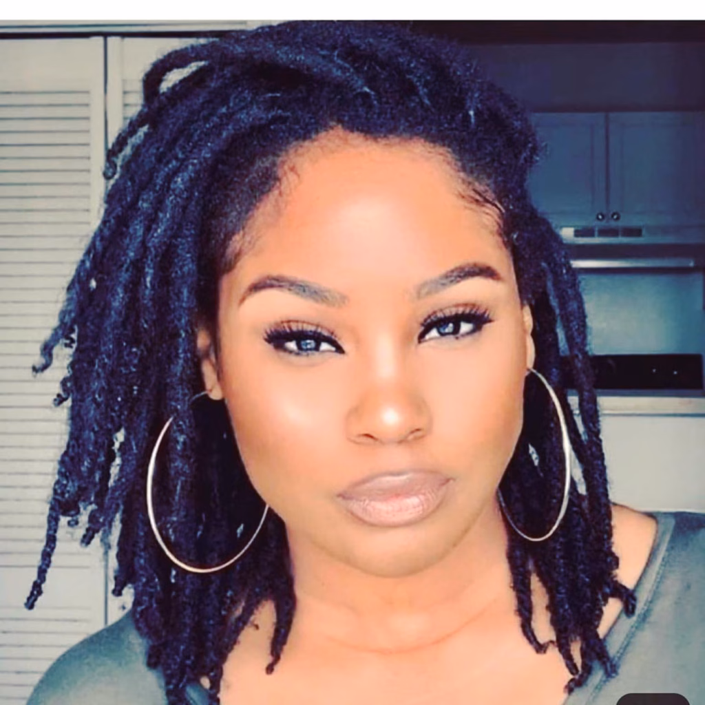 Shoulder-Length Blue Black Locs with Silver Hoop Earrings