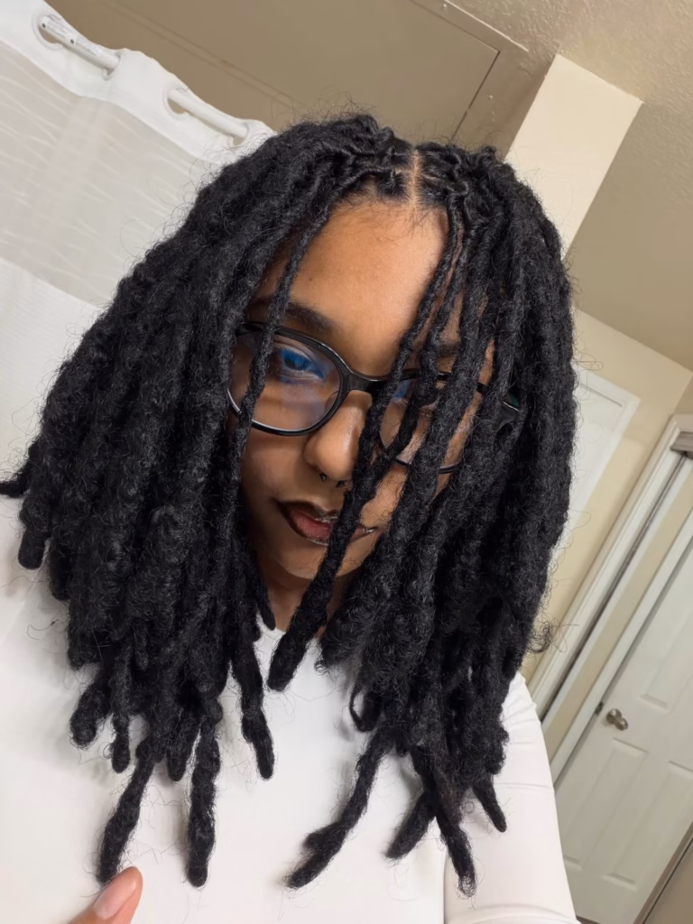 Thick Freeform Locs Falling Forward With Small Round Frames