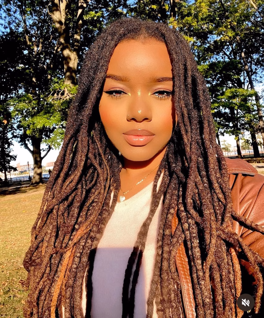 Waist-Length Thick Locs Worn Loose in Natural Light