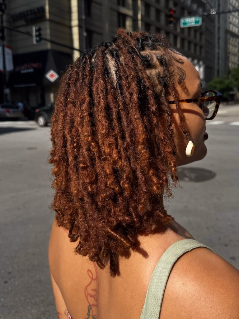 Copper Brown Locs with Natural Curl Ends Worn Down