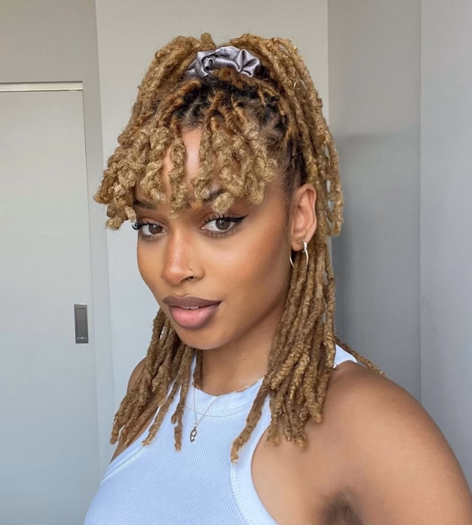 Half-Up Loc Ponytail With Curly Bangs