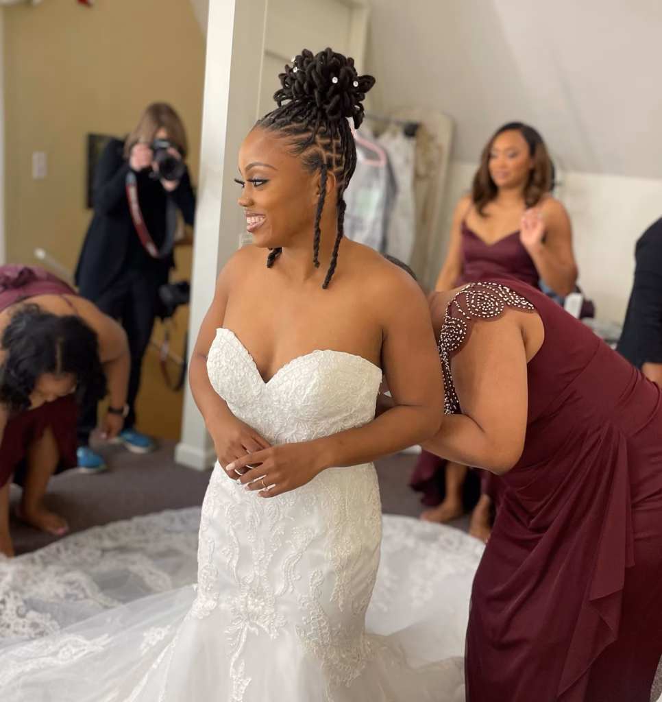 High Loc Bun with Flat-Braided Sides and Two Face-Framing Tendrils