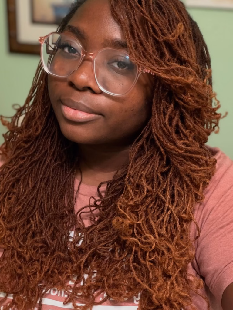 Long Auburn-Colored Sisterlocks Worn Loose With Voluminous Curly Ends