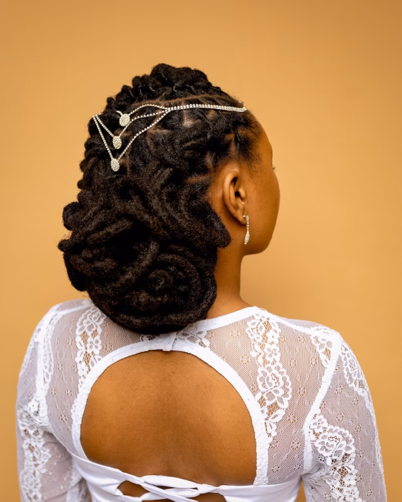 Sculpted Loc Updo with Coiled Rosette Base and Rhinestone Chain Drape